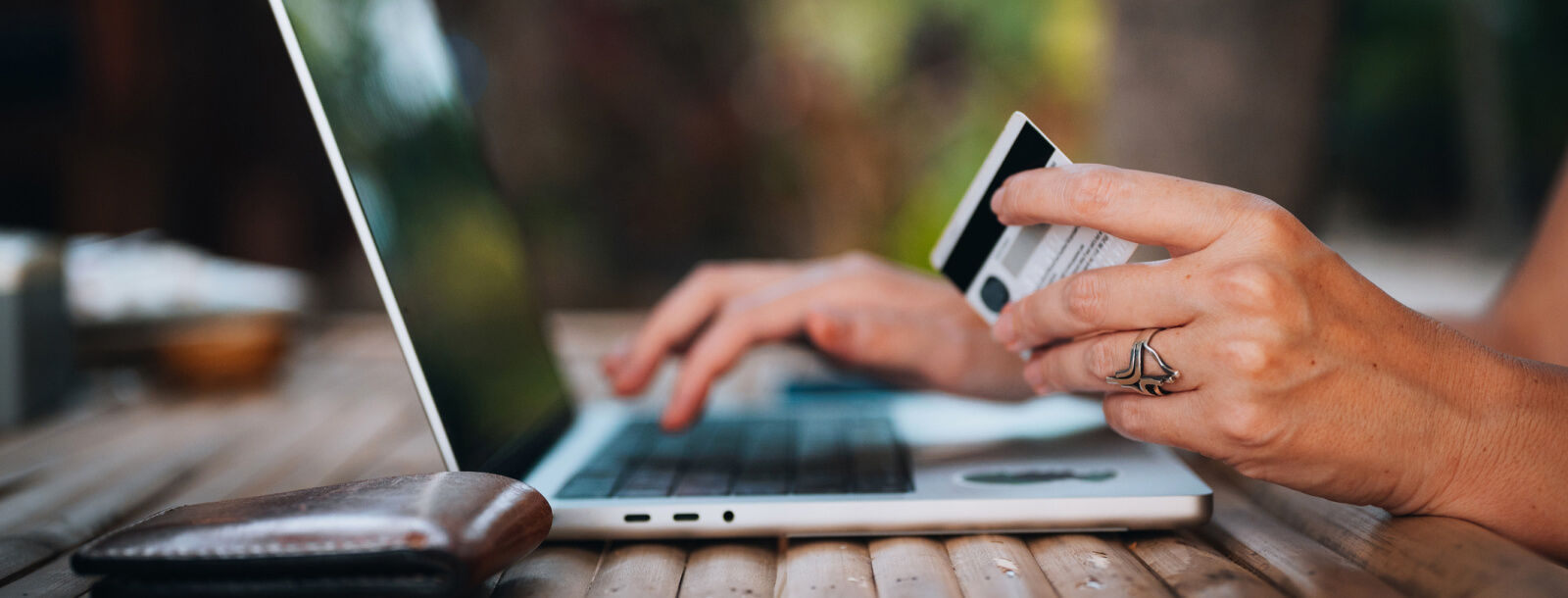 woman with credit/debit card at laptop